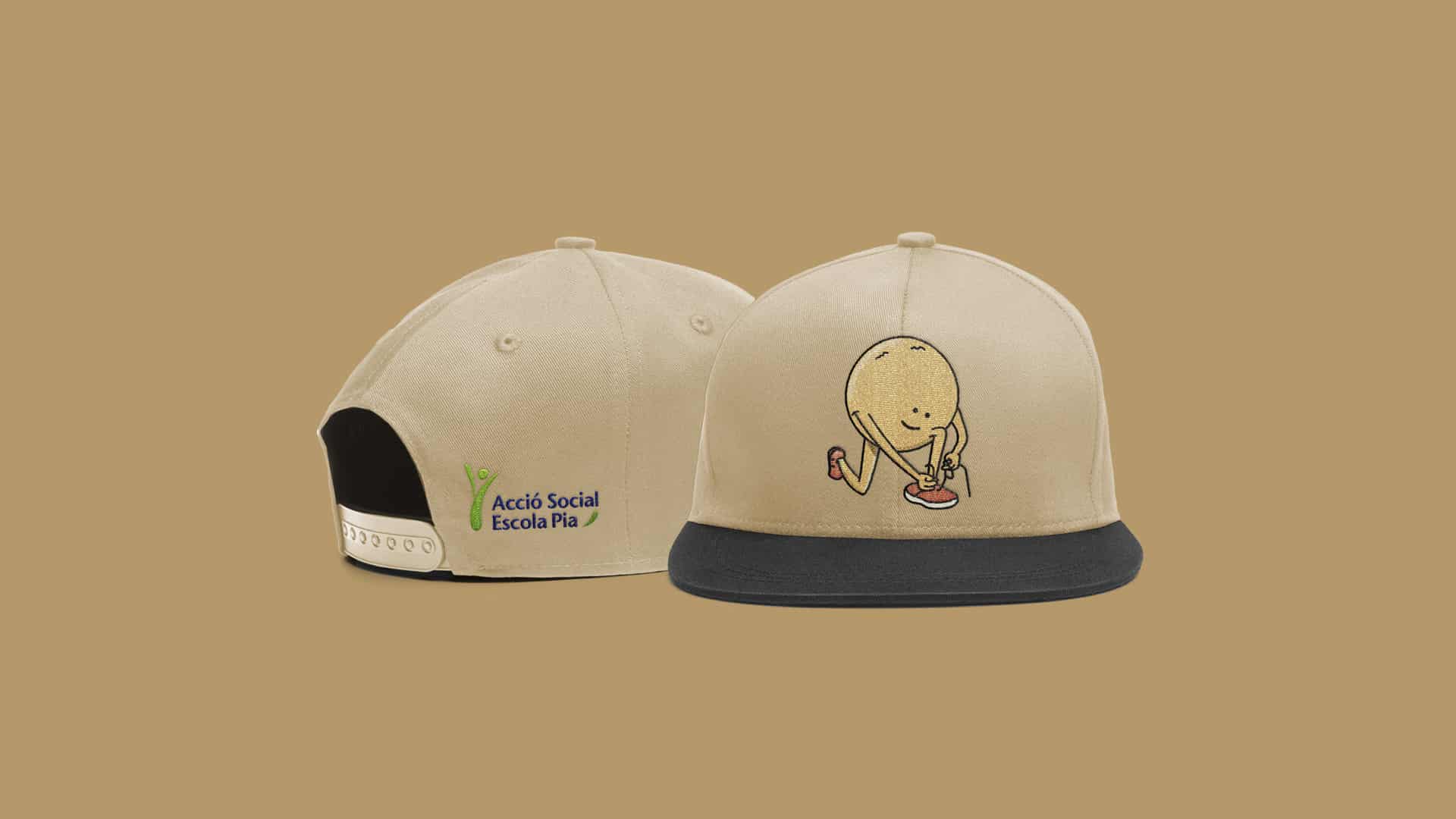 Gorras personalizadas para Acció Social Escola Pia con ilustraciones bordadas, por Nomon Design, agencia de branding